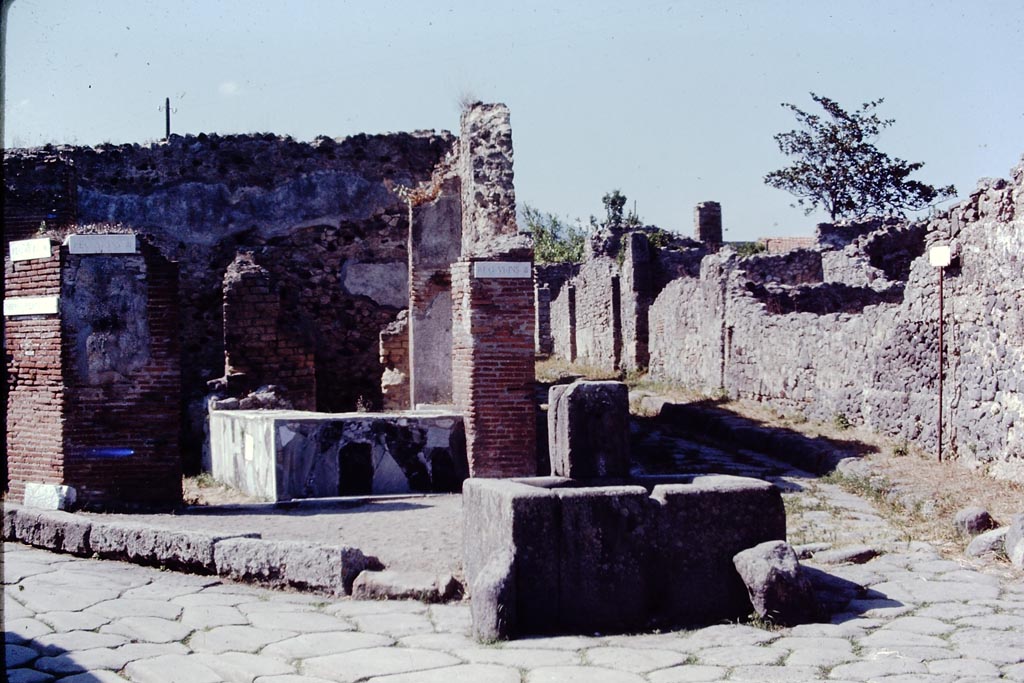 VI.3.20 Pompeii. 1968. 
Looking north towards bar in Via Consolare and fountain at junction with Vicolo di Modesto. Photo by Stanley A. Jashemski.
Source: The Wilhelmina and Stanley A. Jashemski archive in the University of Maryland Library, Special Collections (See collection page) and made available under the Creative Commons Attribution-Non Commercial License v.4. See Licence and use details.
J68f1644

