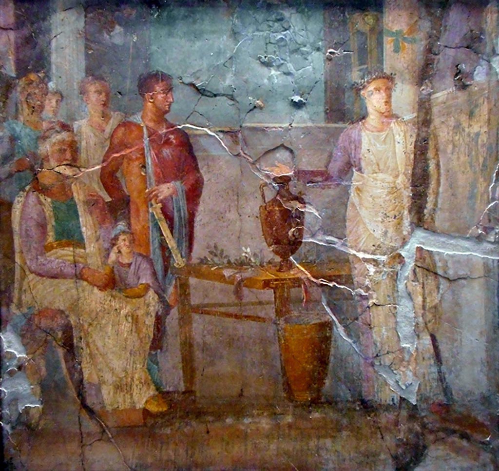 VI.10.2 Pompeii. 
Wall painting of Aeneas consulting Anio or the Vaticinio di Cassandra. This painting was also found in the oecus.
Now in Naples Archaeological Museum. Inventory number 8999.
According to PAH, this is Aeneas consulting Anio, the King of Ortigia, accompanied by Anchises and the little Ascanius.
See PAH II, p. 219, March 1829.
According to Coarelli and Pesando, this is Cassandra prophesising the fall of Troy.
Priam is sitting, with the young Paris leaning on his thigh. Hector is next to them, holding a dagger that is resting on a table.
Cassandra is on the right of the picture, with her hand outstretched.
See similar paintings in I.2.28 and VI.3.7.
See Coarelli F. and Pesando F. et al, 2006. Rileggere Pompei: l’insula 10 della regione VI. Roma: L’Erma di Bretschneider. p. 60-1, Tav. XVII.
Our thanks to Rachel Lowder for helping with this.

