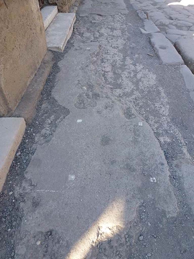 VI.12.5 Pompeii. June 2012. 
Looking east along pavement outside VI.12.4 and VI.12.5 (top), on north side of Via della Fortuna.
Photo courtesy of Michael Binns.

