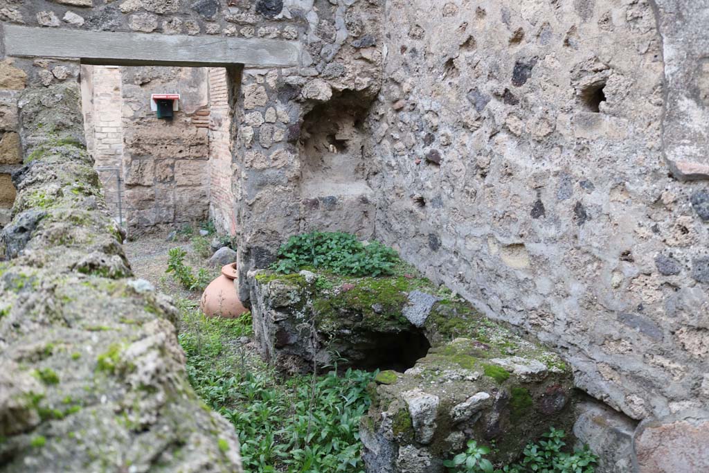 VI.14.36 Pompeii. December 2018. 
Looking west towards hearth against north wall near doorway to bar-room. Photo courtesy of Aude Durand.
