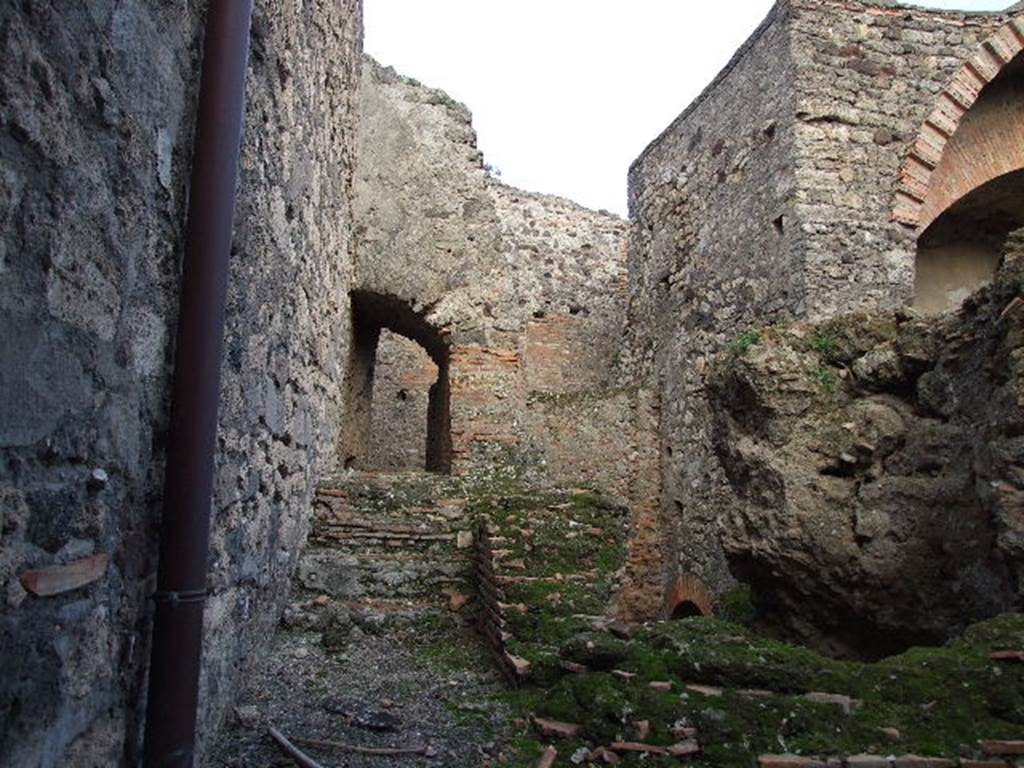 VII.1.8 Pompeii. December 2006. Praefurnium 7 with corridor leading east to VII.1.15, up the steps and through arch.