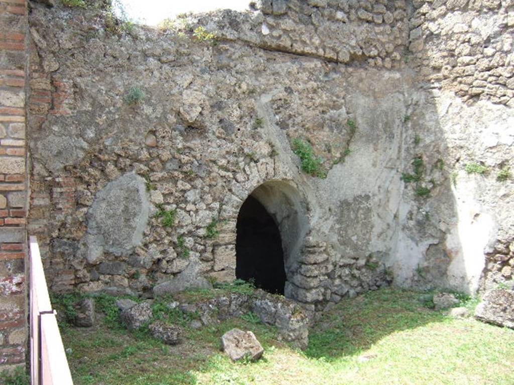 VII.2.41 Pompeii. May 2006. West wall with entrance to cellar.