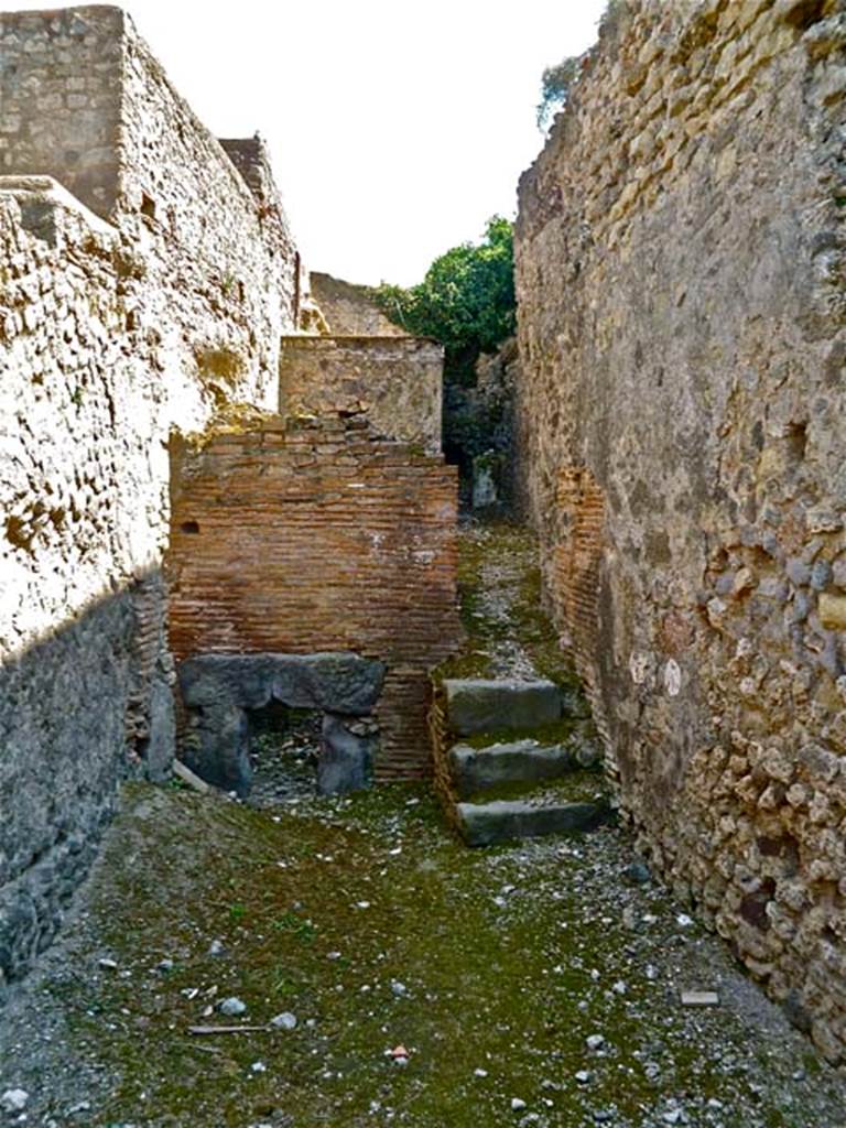 VII.5.7 Pompeii. May 2011. Looking south from entrance (26)  across the furnace room (25). Remains of praefurnium front (27) between the mens and womens baths. Photo courtesy of Michael Binns.