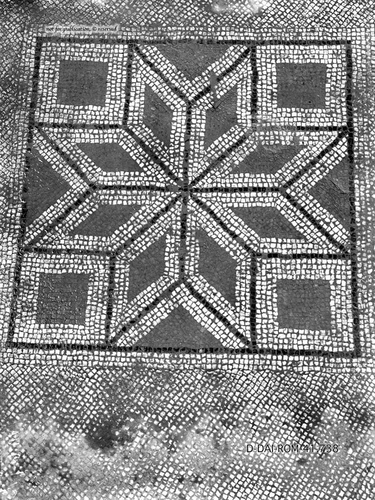 VII.6.7 Pompeii. 
Room 52, mosaic floor with white background, in the middle was a square showing a star resulting from eight white diamonds with black band around, each comprising a smaller, red diamond.  
DAIR 41.738. Photo © Deutsches Archäologisches Institut, Abteilung Rom, Arkiv.
See Pernice, E.  1938. Pavimente und Figürliche Mosaiken: Die Hellenistische Kunst in Pompeji, Band VI. Berlin: de Gruyter, (p.89-90, and taf. 41,4 above).
According to PPM –
“The floors were for the most part in cocciopesto, lavapesta intermingled with brick, or white mosaic with emblemata already removed during the explorations of the Bourbon age (cf. PAH 1,2, p.144, 10 April 1762) and today no longer found, although documented by Pernice. 
Among the lost motifs are the hexagon with prospective cube of tiles in the cubiculum (40), or the 8-pointed star resulting from the combination of its many diamond-shapes inserted into a square in the cubiculum (52), a room also known for the lowered vaulted cover on the alcove and flat ceiling on the rest of the room, or finally the kantharos outlined in black, red, yellow and white tesserae, placed in the threshold of the triclinium and destroyed by the roots of spontaneous vegetation in the winter of 1928.”
( I pavimenti erano per lo piu in cocciopesto, lavapesta con frammisti laterizi che ne ravvivavano il colore o a mosaico bianco con emblemata gia asportati durante l’esplorazione di eta borbonica (cfr, PAH 1,2, p.144, 10 aprile 1762) e oggi non piu riscontrabili, anche se documentati da Pernice. 
Tra i motivi perduti ricordiamo l’esagono con cubo prospettico di piastrelle nel cubicolo (40), o la stella a 8 punte risultante dalla combinazione di altrettanti rombi inserita in un quadrato nel cubicolo (52), ambiente notevole anche per la copertura a volta ribassata sul’alcova e piana sulla restante parte della stanza, o, infine, il kantharos delineato in tessere nere, rosse, gialle e bianche, posto nella soglia del triclinio e distrutto dalle radici della vegetazione spontanea nell’inverno del 1928. 
See PPM, VII, 7, (p.176)

