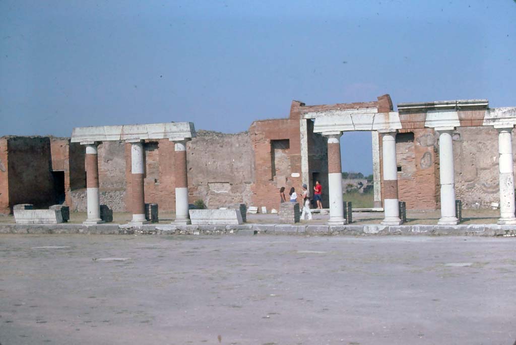 VII.8.00 Pompeii, 7th August 1976. Looking east across Forum towards Eumachia building portico. 
Photo courtesy of Rick Bauer, from Dr George Fay’s slides collection.
