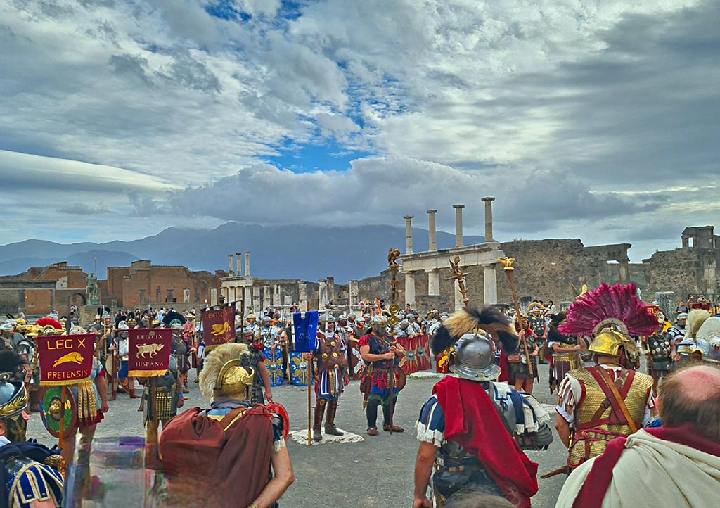 VII.8 Pompeii. 28th September 2024. 
Looking south-west across Forum, standard bearers during “Ludi Pompeiani” event. Photo courtesy of Giuseppe Ciaramella.

