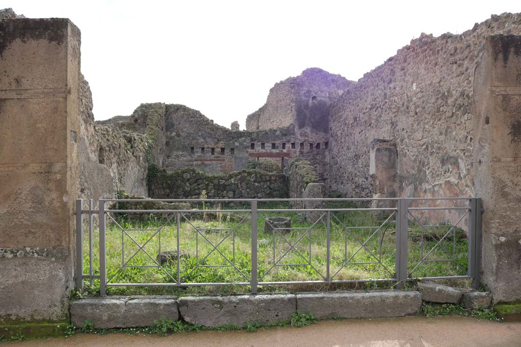 VII.12.11 Pompeii. December 2018. 
Looking south across workshop towards rear room with corridor to rear on right. Photo courtesy of Aude Durand.


