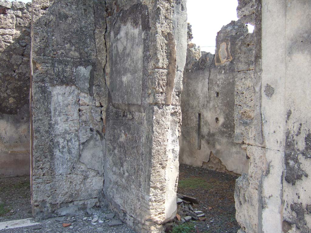 VII.15.2 Pompeii. September 2005. South-east corner of atrium.
Doorway to room to east side of entrance corridor, (on right).  
This room used to have two lines of shelving along its south wall and was paved with cocciopesto. 
There is a bed recess at its east end.
In this room a small square of marble was found, on which Niobe grieving for the death of her sons was depicted.
