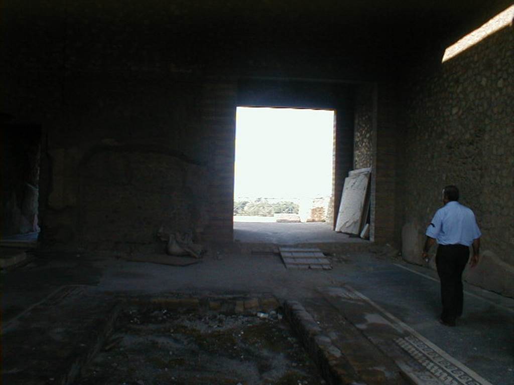 VII.16.17-22 Pompeii. May 2006. Looking west across atrium and impluvium.
According to Jashemski, on the left was a doorway with a grand view through a large room to a courtyard garden (not photographed).
Beyond the garden was a stately oecus. In the courtyard garden, a fountain jet rose in the middle of the round pool. Faint traces show that the interior of the pool had been painted blue. A gutter around the edge of the pool carried off roof water.
See Jashemski, W. F., 1993. The Gardens of Pompeii, Volume II: Appendices. New York: Caratzas. (p.203, A, fig.235)
