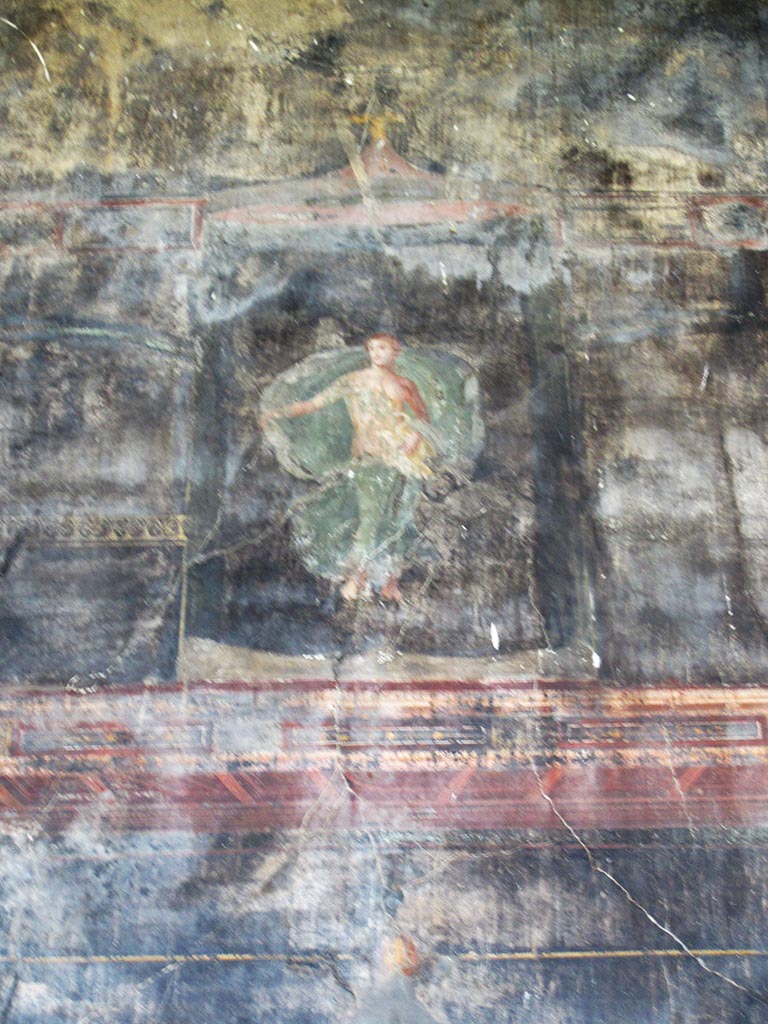 VII.16.17-22 Pompeii. May 2012.  
Oecus 62, painted wall figure of Leda with the swan (Zeus) on her lap, from upper centre of east wall of oecus.
Photo courtesy of Marina Fuxa.
