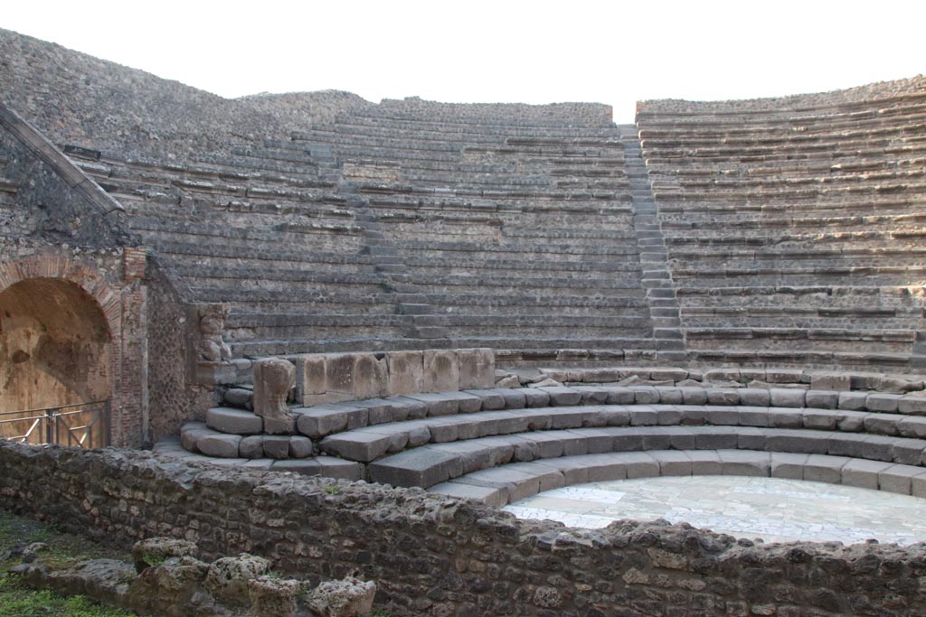VIII.7.18 Pompeii. October 2023. 
Looking west along site of stage, towards Tribunal over arched entrance, on left. Photo courtesy of Klaus Heese.
