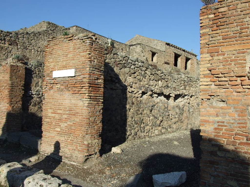 IX.3.9 Pompeii. December 2007. Entrance, looking towards north wall.
On the pilaster that separates these two shops, on the left between IX.3.8 and 9, a mutilated graffiti was found   
Titus ?   rog(at)   [CIL IV 884]
See Della Corte, M., 1965.  Case ed Abitanti di Pompei. Napoli: Fausto Fiorentino. (p.162)
According to Della Corte, also found on this pilaster on the left, was the graffiti
Multum  pistores  rogant     [CIL IV 886]  
This graffiti was written in support of the candidate Giulio Polibio  (see IX.3.8).
See Della Corte, M., 1965.  Case ed Abitanti di Pompei. Napoli: Fausto Fiorentino. (p. 159)

