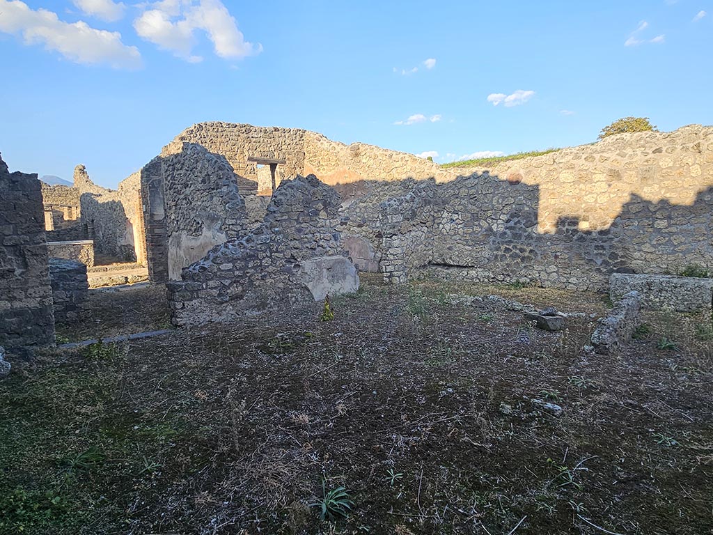 IX.7.21 Pompeii. November 2024. 
Looking north-east across atrium, from entrance doorway, with doorway into IX.7.22, on left. Photo courtesy of Annette Haug.
