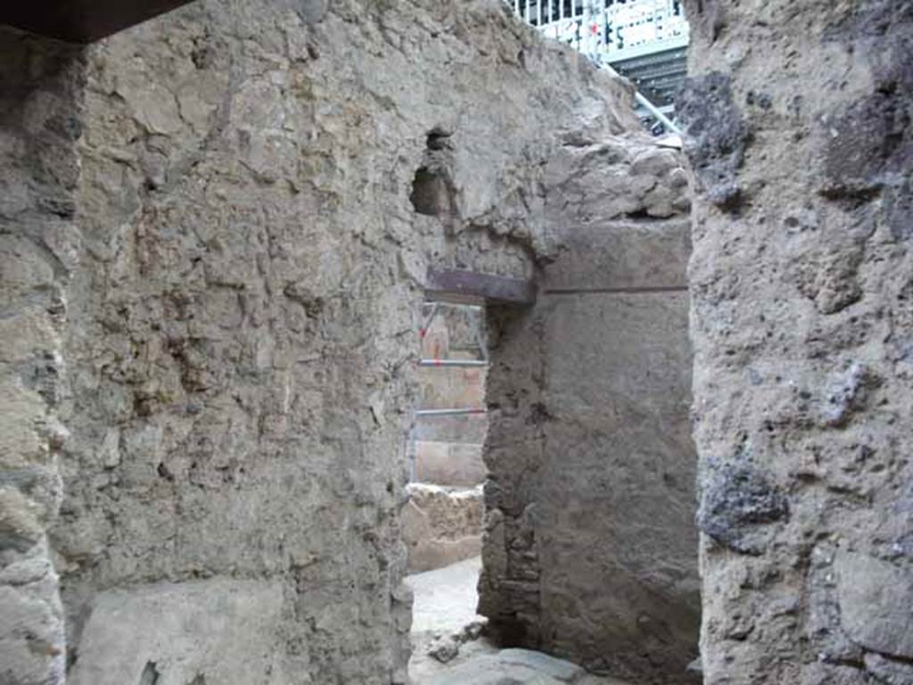 IX.12.8 Pompeii. May 2010. Entrance doorway and south wall of stable “n”. Looking through doorway into room “n1” of IX.12.6.
