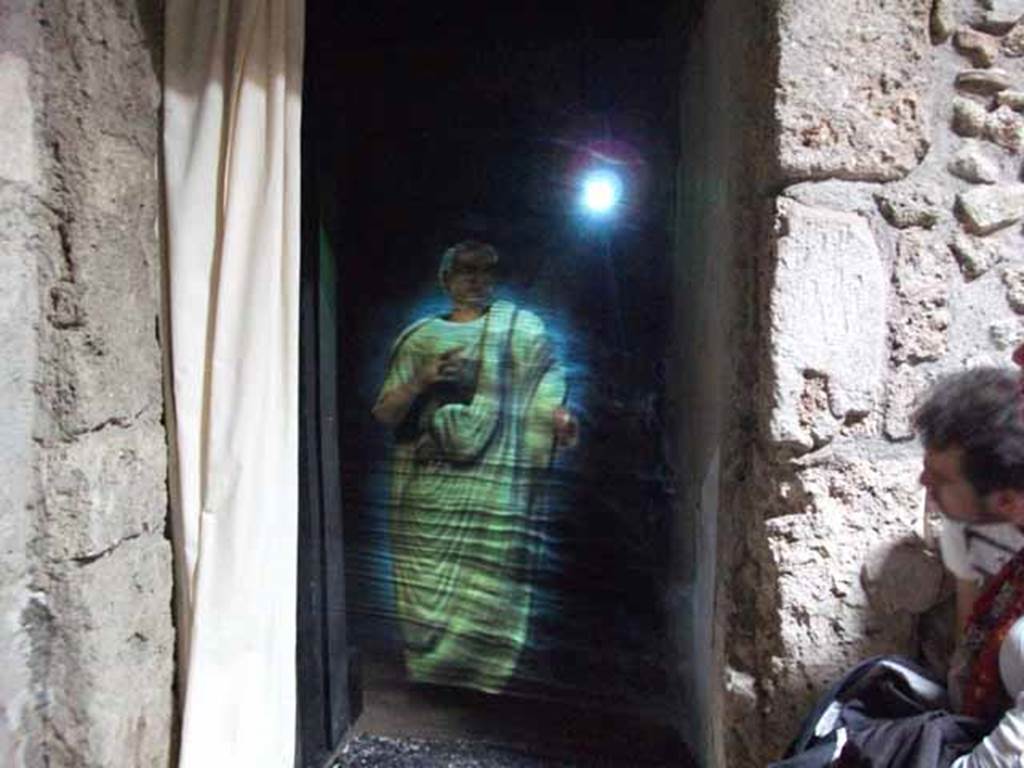 IX.13.1-3 Pompeii. May 2010.  Doorway to room 5, and hologram of Julius Polybius.