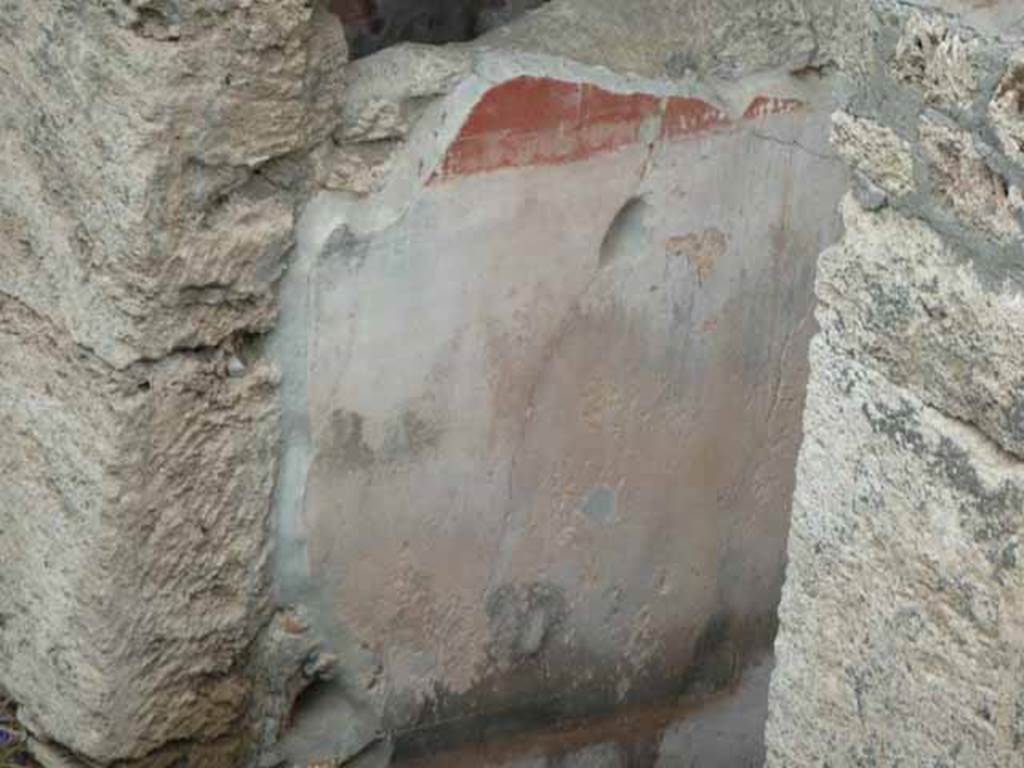 IX.14.c Pompeii. May 2010. Room 1, entrance corridor or fauces, north wall (left). The walls of the fauces or entrance corridor were painted with a black plinth, of large decorations likewise black. The red frieze was divided into rectangles by thin bands. The painting on the north wall was the best preserved. See Notizie degli Scavi di Antichit, 1911, p. 374.
