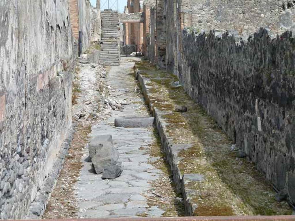 Unnamed vicolo between VIII.1.3 and VIII.1.1. May 2010. Looking east from the south end into Vicolo di Championnet. 
