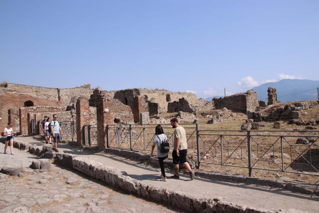 Via delle Terme, south side. September 2019. Looking south-east across VII.6, from near VII.6.7, between brick pilasters. 
Photo courtesy of Klaus Heese.
