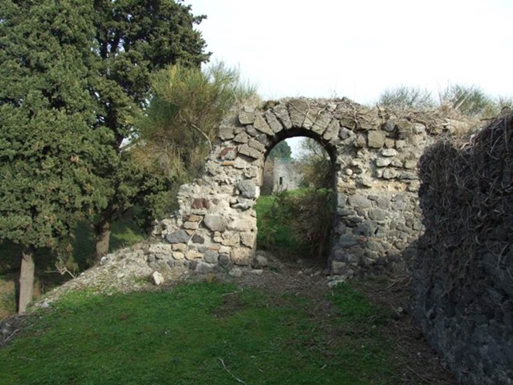 Tower XII, Pompeii. December 2007. 
Looking east through eastern doorway of remaining room on middle floor, from interior of Tower XII. 
Tower XI is visible along the top of the walls. 




