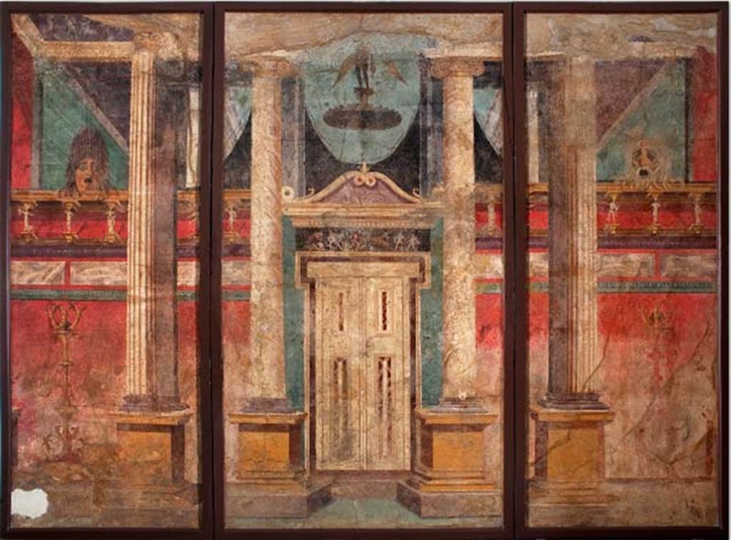 Villa of P. Fannius Synistor at Boscoreale. Room G, summer triclinium, west wall. Architectural scene with large portico decorated with Corinthian columns, pilasters and a set of imitation doors. There are two candelabra in front of the wall, each with figures of Victory at the top and cupids at the bottom. The cornice of the wall is supported by Satyrs and Maenads. On top of the wall stand two tragic masks. At the top of the door is a frieze with a hunting scene, reminiscent of Artemis. A winged Eros flies above the door. Now in Naples Archaeological Museum.  Inventory number s.n. 1. See Schefold, K., 1962. Vergessenes Pompeji. Bern: Francke. p. 33.