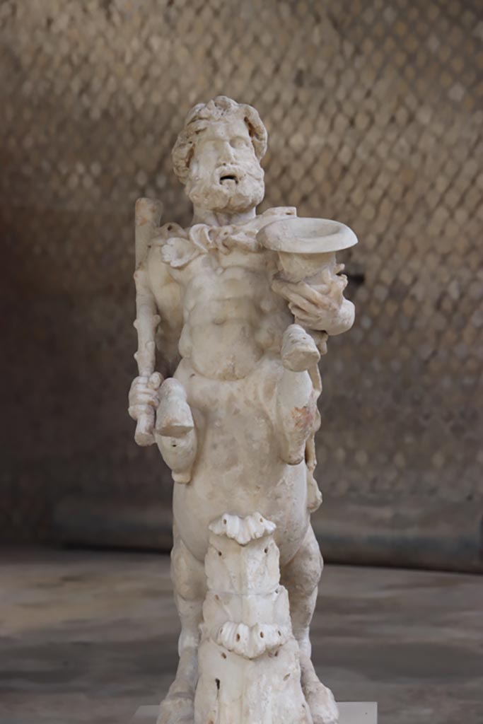 Villa of Poppaea, Oplontis, October 2023. 
Statuette of Centaur holding a club and a crater, on display in Room 21. Photo courtesy of Klaus Heese. 

