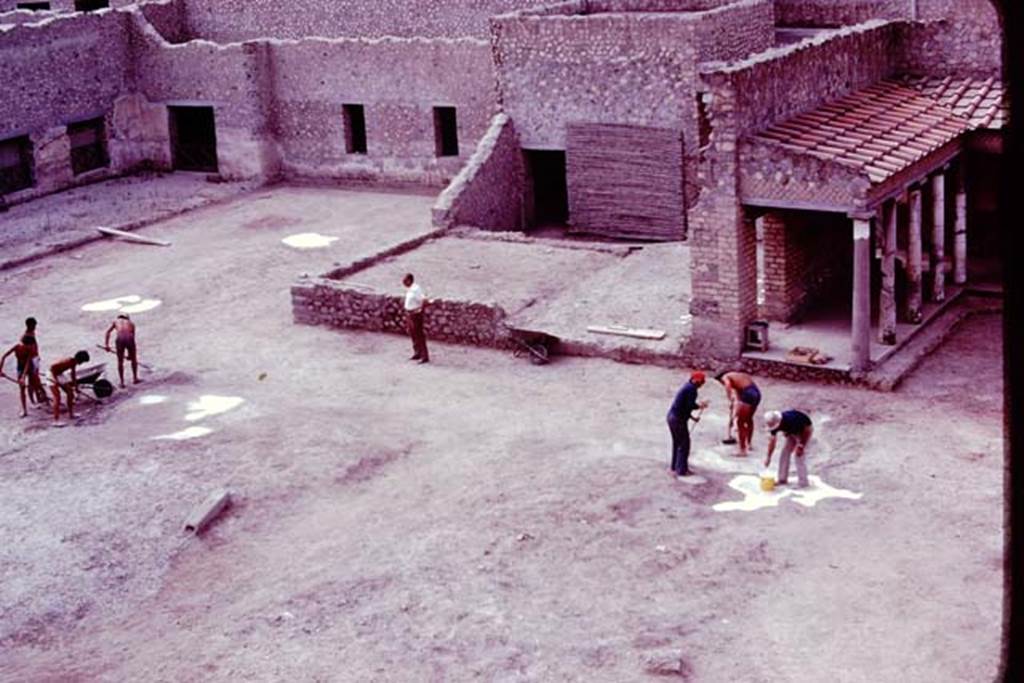 Oplontis, 1977. Cleaning and tidying the north garden, ready for the balloon photos. The root cavities are being painted white, to ensure they show up from the air. Photo by Stanley A. Jashemski.   
Source: The Wilhelmina and Stanley A. Jashemski archive in the University of Maryland Library, Special Collections (See collection page) and made available under the Creative Commons Attribution-Non Commercial License v.4. See Licence and use details. J77f0248
