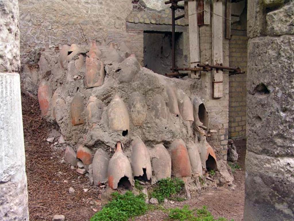 Oplontis, Villa of Lucius Crassius Tertius. March 2005. Room 18bis, west end. 
Some of the 400 amphorae found, many stacked upside down. 
Photo courtesy of Massimo Gravili.
According to Malandrino there were many washed amphorae inverted for drying. 
This showed this villa was inhabited and active at the time of the eruption. 
See Malandrino, C., 1981, Sylva Mala II, p. 3-4.
