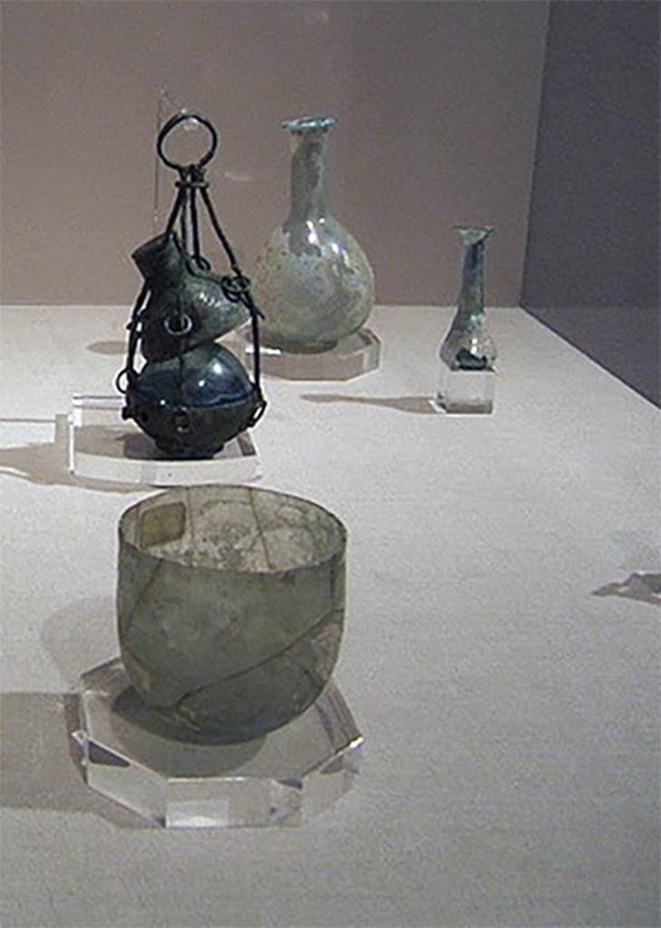 Gragnano, Villa rustica in Località Carmiano, Villa A. Items found in the villa.
Stabiae Antiquarium, inventory numbers 
63571 round glass ointment or perfume flask, from near lararium.
63589 tapered glass ointment or perfume flask, from room 3.
63437 bronze hanging perfume holder, from room 1.
61406 glass cup is from Santa Maria La Carità, Villa Petraro.
See Bonifacio G., 2004. In Stabiano: Exploring the Ancient Seaside Villas of the Roman Elite. Castellamare: Nicola Longobardi, p. 132, p. 137.


