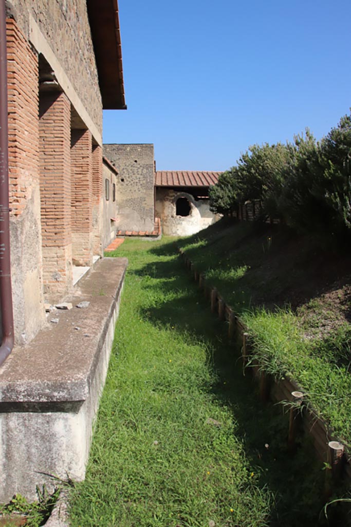 Stabiae, Villa Arianna, October 2022. 
Looking east at rear of Triclinium A, with the unexcavated, on the right. Photo courtesy of Klaus Heese.
